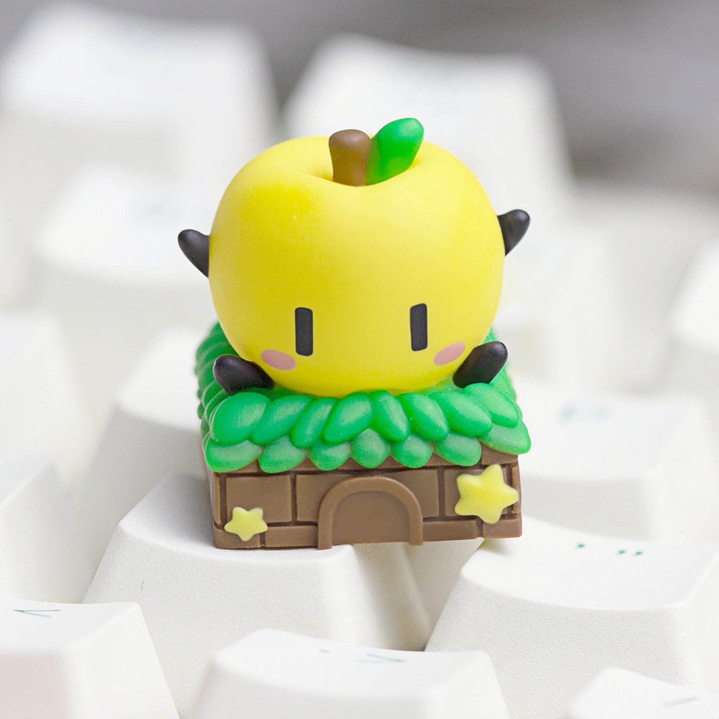 Keycapper sunny yellow Stardew Valley Junimo artisan keycap close-up on a white mechanical keyboard setup.