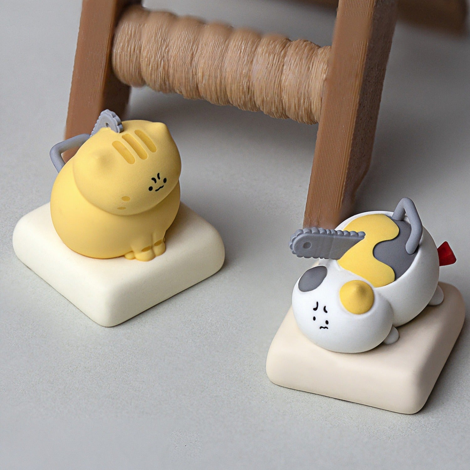 Keycapper Chainsaw Kitty yellow tabby cat and calico cat keycaps resting on desk setup