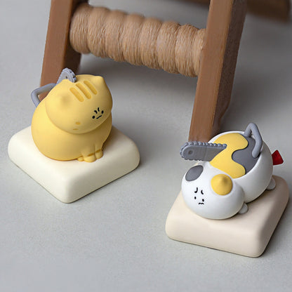 Keycapper Chainsaw Kitty yellow tabby cat and calico cat keycaps resting on desk setup