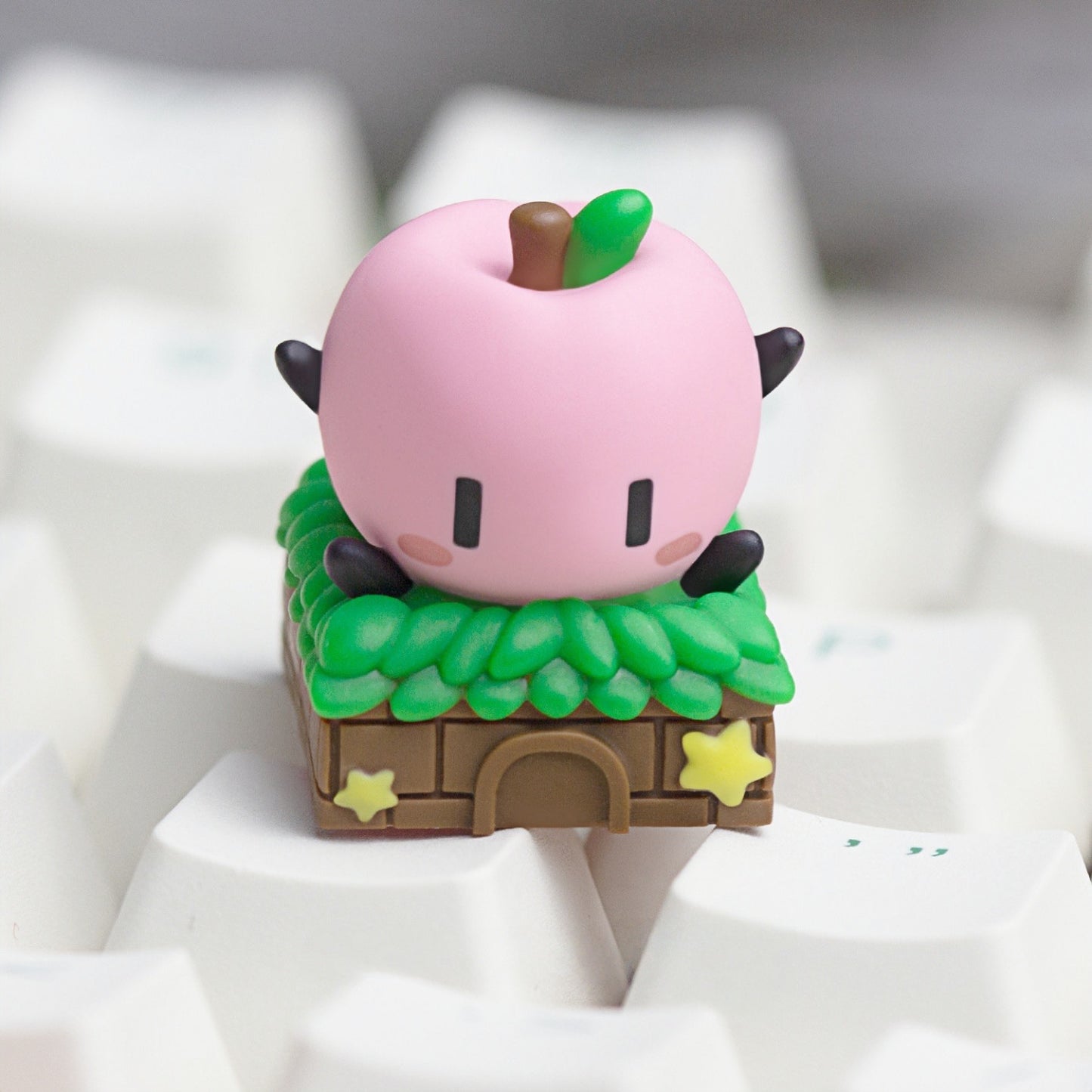 Keycapper cozy pink Junimo custom resin keycap inspired by Stardew Valley, mounted on white keyboard keycaps.