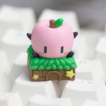 Keycapper cozy pink Junimo custom resin keycap inspired by Stardew Valley, mounted on white keyboard keycaps.