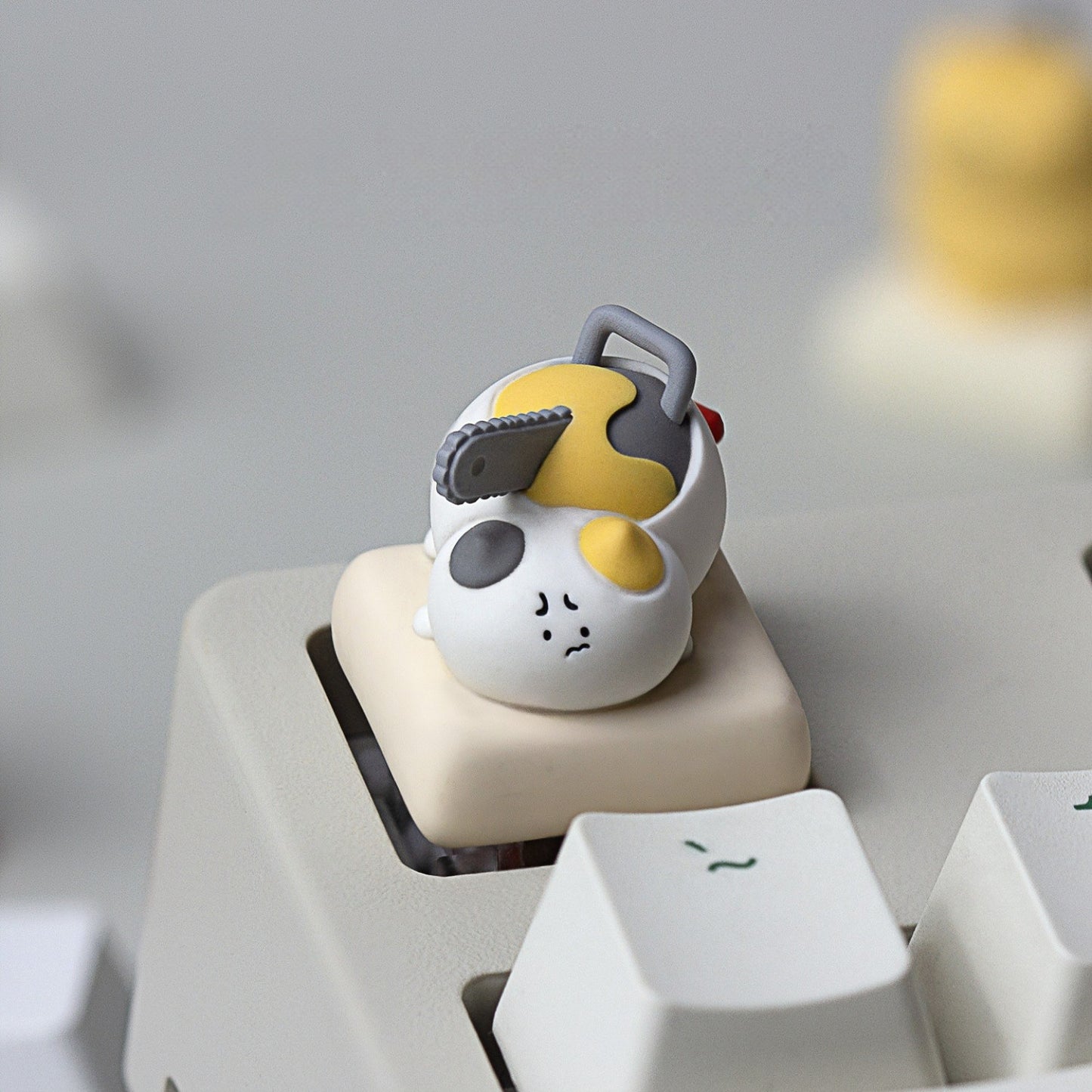 Keycapper Chainsaw Kitty calico resin artisan keycap with chainsaw blade close up
