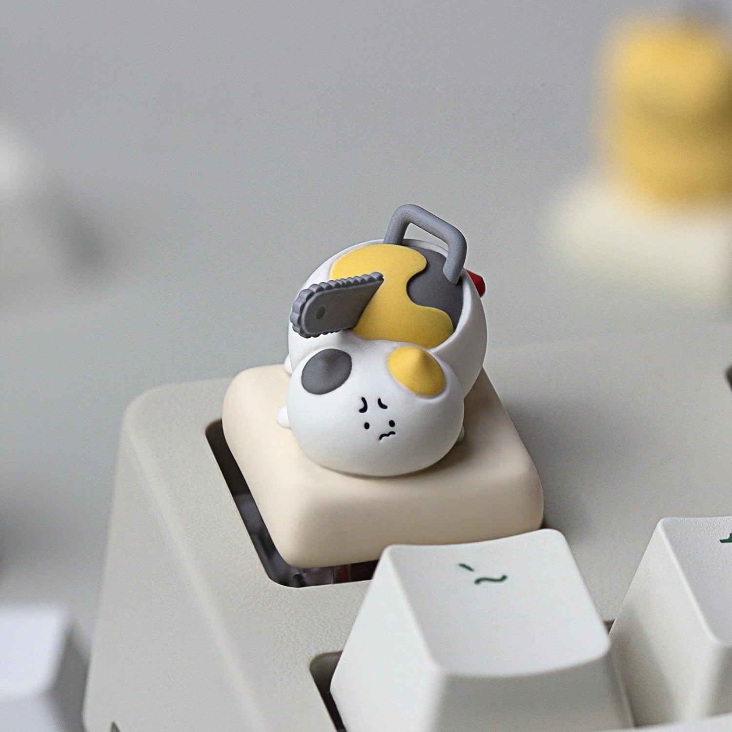 Keycapper Chainsaw Kitty calico resin artisan keycap with chainsaw blade close up