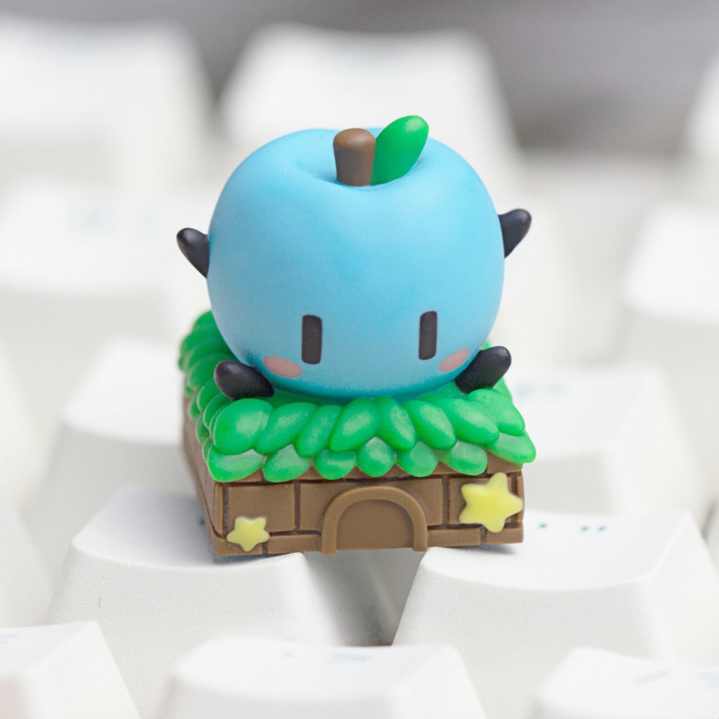Keycapper sky blue Junimo apple sprite custom keyboard keycap with detailed thatched roof hut design.