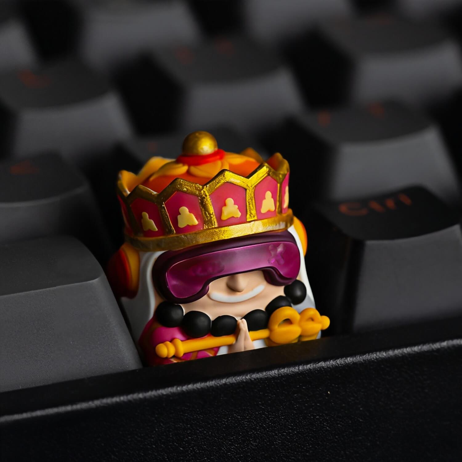 Close-up of Keycapper Cyberpunk Tang Seng monk artisan keycap with golden crown and magenta cyber visor on a dark keyboard.
