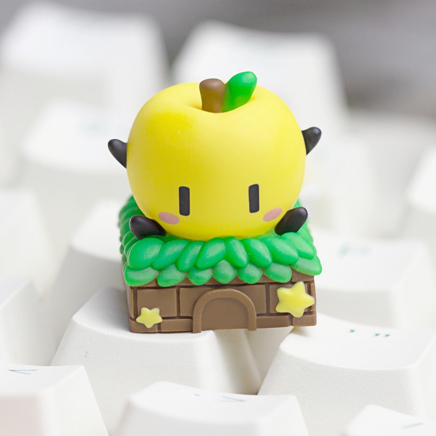 Keycapper sunny yellow Stardew Valley Junimo artisan keycap close-up on a white mechanical keyboard setup.