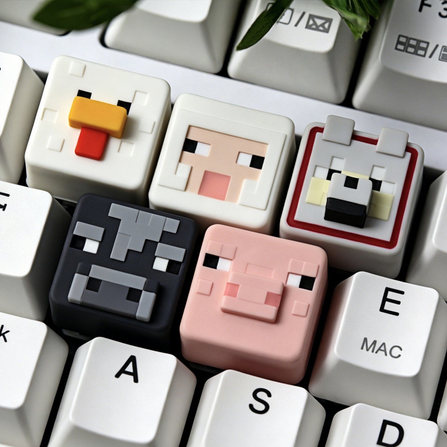 Keycapper™ Minecraft Cube Series Artisanal Keycaps – A collection shot featuring six distinct 3D voxel Animal and Monster Mob heads (Chicken, Sheep, Wolf, Cow, Pig) installed in a row on a white mechanical keyboard, showcasing the detailed pixel art.