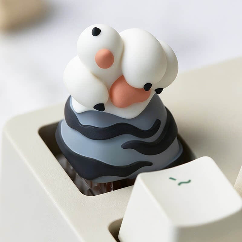 Keycapper white tiger paw resin artisan keycap with dark grey stripes and claws mounted on a mechanical keyboard.