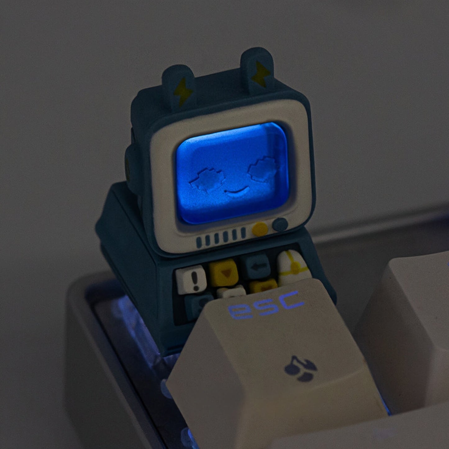 Keycapper blue retro computer artisan keycap with its screen brilliantly lit up in neon blue by the mechanical keyboard's under-glow.