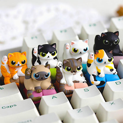 A collection of Keycapper Cat Grooming handmade resin artisan keycaps in various breeds sitting on white mechanical keyboard switches.