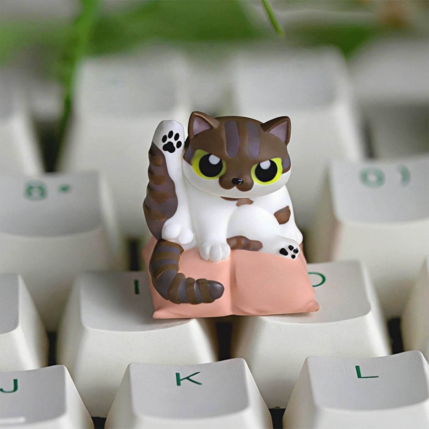 Keycapper Cat Grooming artisan keycap featuring a playful brown tabby cat doing a funny yoga stretch on a peach cushion.